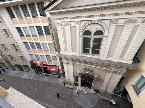 an overhead view of a building with people standing outside at San Carlo Luxury Apartments in Lugano