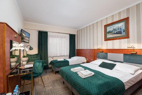 Postel nebo postele na pokoji v ubytování Hotel Rejs