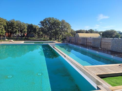 une grande piscine avec de l'eau bleue dans l'établissement Grand T2 et jardin proche plages, à Lecci