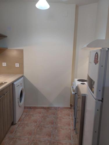 a kitchen with a refrigerator and a washing machine at Rouchotas Studios by Viktor 1rst Floor in Argostoli