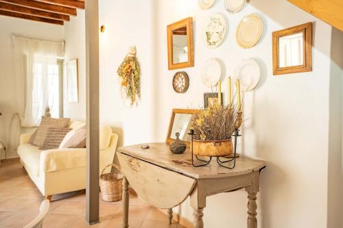 a living room with a table and a couch at OURANIAS HOUSE in Kalymnos