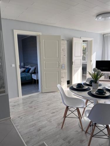 a living room with a table and chairs and a couch at Nõva, Külaliskorter, mere ääres in Nõva
