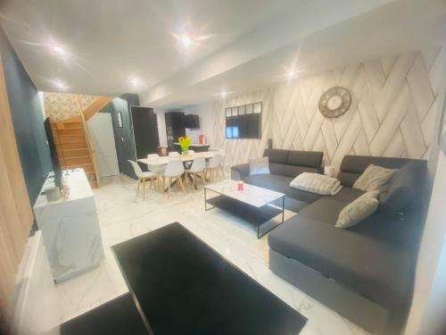 un salon avec un canapé et une table dans l'établissement Maison Trésor, à Longny-au-Perche