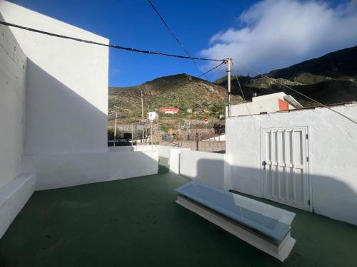 a balcony with a bench on the side of a building at Casa ADOLFO in Almáciga