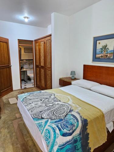 a bedroom with a king sized bed in a room at Los Pinos de Zorritos Condominio in Zorritos