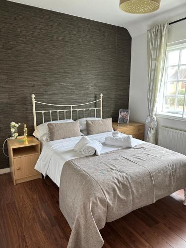 a bedroom with a large bed with white sheets at Cosy 2-Bed Retreat in Hampstead in London