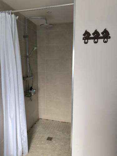 a shower with a shower curtain in a bathroom at Vacances à Nova 1 in Martageix