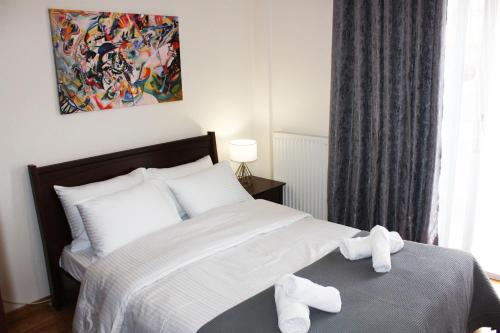 a bedroom with a bed with white towels on it at Family Spacious Apartment Veria in Veria