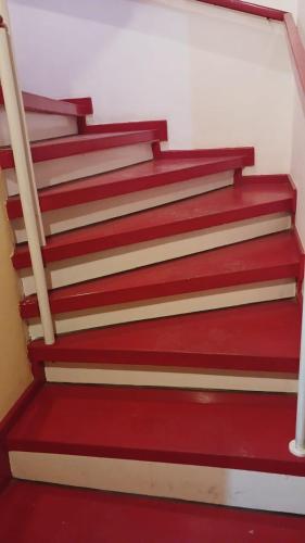a set of red stairs in a building at Khan House in Sheki
