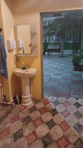 a bathroom with a sink and a tile floor at Khan House in Sheki