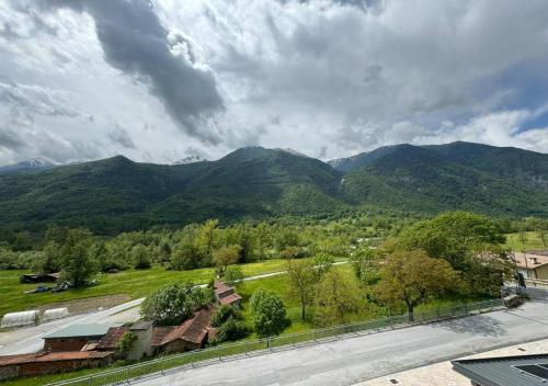 a view of a mountain range with trees and a road at Appartamento Rustico con vista sulla Valle Stura in Aisone