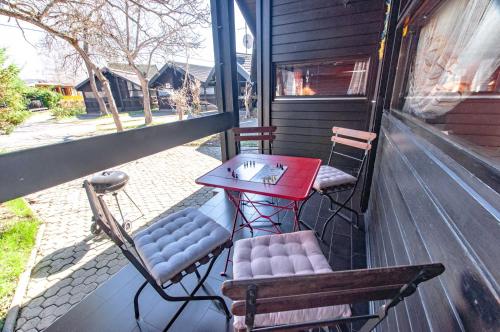a table and two chairs on a porch at Apartma Retro house Čatež in Čatež ob Savi