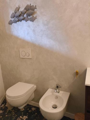 a bathroom with a toilet and a sink at Relaxing Break Lario in Gravedona