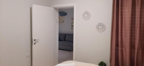 a door to a room with a couch and a mirror at מול ים המלח in Ovnat