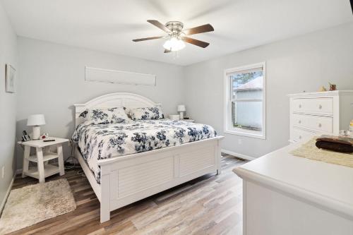 a white bedroom with a bed and a ceiling fan at Cottages 7 & 9 - Fire Pit - Beach - Sleeps 8 in Lincoln Junction