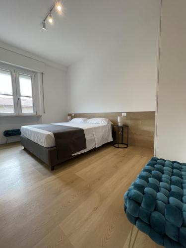 a bedroom with a bed and a blue ottoman at Sirolo appartamenti in Sirolo