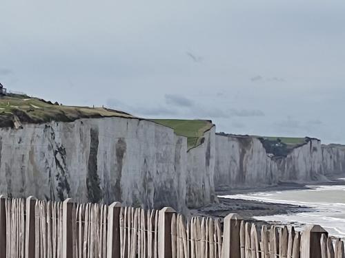 a painting of a fence next to the beach at Studio "La fleur de Lys" in Ault