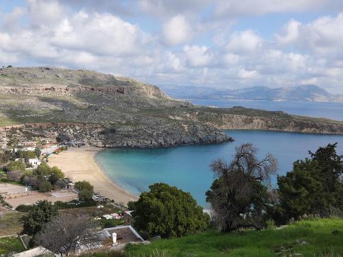 a view of a beach and a body of water at Lindos Esel Suites in Líndos