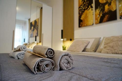 a group of rolled up towels on a bed at House 105 Suite Apartment in Perugia