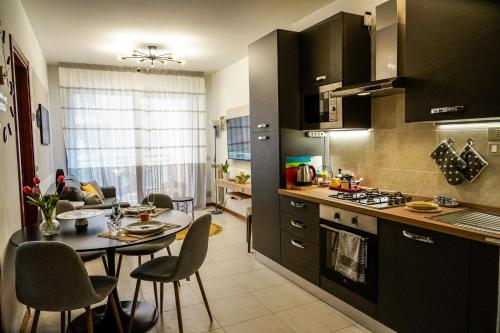 a kitchen with a table and a dining room at House 105 Suite Apartment in Perugia
