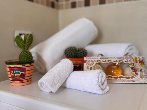 a white counter with a figurine and a cactus at Bella Tao Apart in Taormina