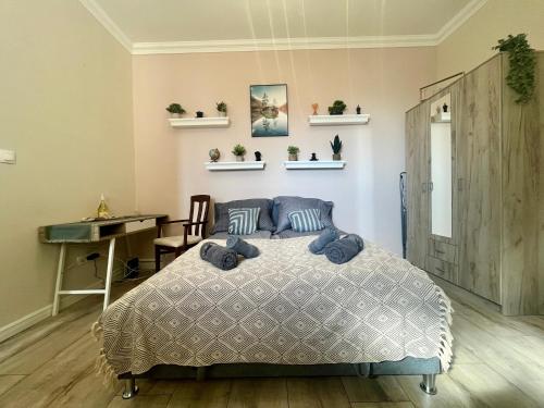 a bedroom with a bed and a desk in it at City Centre Piac Flat in Debrecen