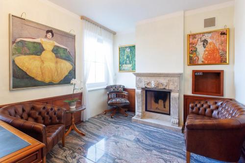a living room with two couches and a fireplace at Luxury Villa with Indoor Pool, Jacuzzi, Sauna & Breathtaking City View in Klosterneuburg