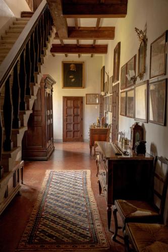 a living room with a staircase and a stair case at Castello in Lucignano
