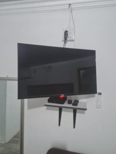 a flat screen tv hanging on a wall at Divine villa in Louis Trichardt