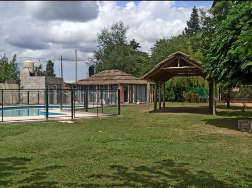 a pavilion next to a swimming pool with a pool at Complejo EL MIRADOR in Olavarría