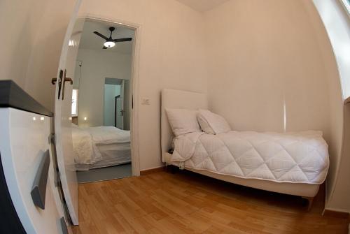 En eller flere senge i et værelse på Nuovo appartamento - Casa D'Amaldi