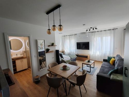 a living room with a couch and a table at Surčin Central Stay in Surčin