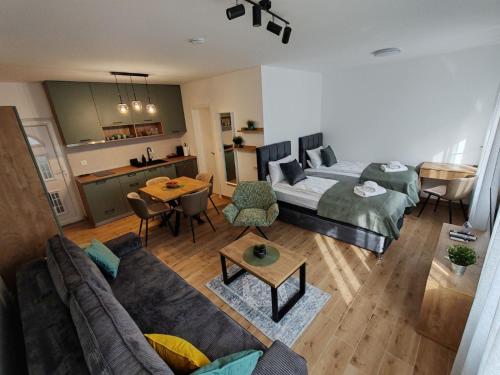 a living room with a couch and a bed at Surčin Central Stay in Surčin