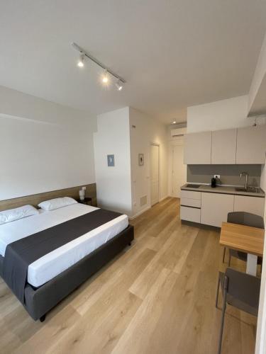 a large bedroom with a bed and a kitchen at Sirolo appartamenti in Sirolo