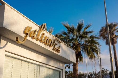a walmart sign on the side of a building with palm trees at Yalinn Boutique Hotel in Yalıkavak
