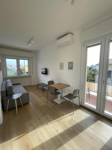 a living room with a couch and a table at Sirolo appartamenti in Sirolo