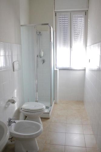 a bathroom with a shower and a toilet and a sink at Appartamenti Leonardo in Rho