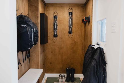 a room with hiking equipment on the wall at BÕSKI - Refuge de luxe in Stoneham
