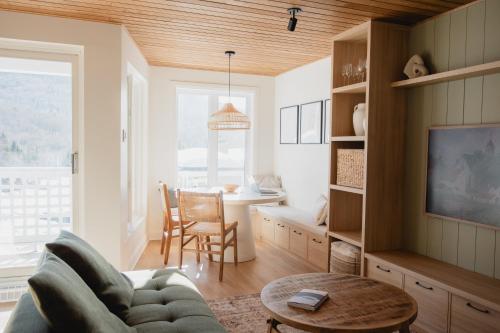 a living room with a couch and a table at BÕSKI - Refuge de luxe in Stoneham