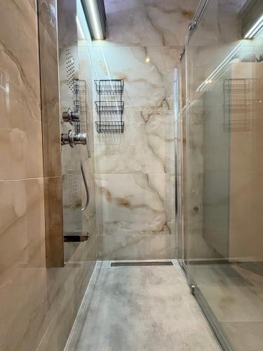 a shower with a glass door in a bathroom at eliTe deluxe 4 skyview in Kavála