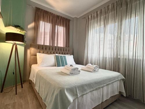a bedroom with a bed with towels on it at eliTe deluxe 4 skyview in Kavála