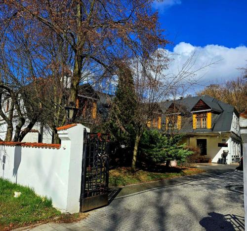 a house with a gate on a street at Zajazd Rybaki in Płock