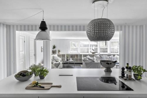 a kitchen and living room with a white counter top at Cozy vacation home very close to the beach in Tisvilde
