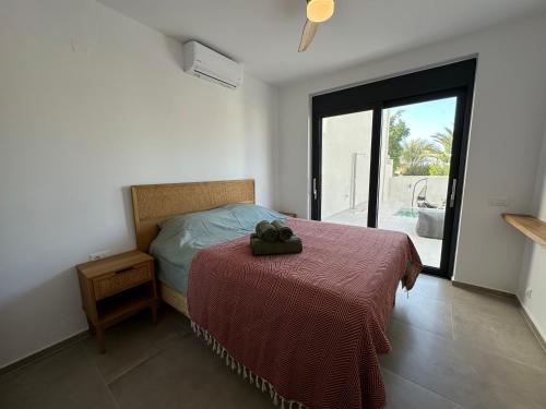 a bedroom with a bed with a purse on it at Villa SAMBA in Kamilari