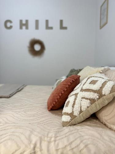 a bed with two pillows on top of it at Boho Luxe Terrace - Brand New & Terrace in St Julian's