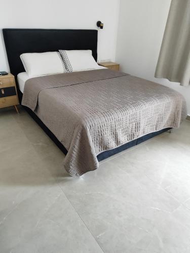 a bedroom with a bed and a tile floor at מול ים המלח זוהר במדבר in Neve Zohar