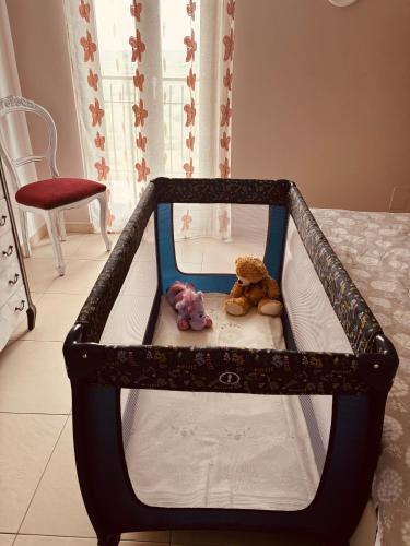 a baby crib with two teddy bears on it at Massanè Casa Vacanza in Ginosa