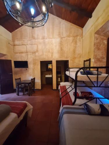 a room with a bunch of bunk beds in it at Hotel California in Antigua Guatemala