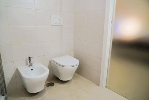 a bathroom with a toilet and a sink at Dimora Antica Falegnameria - tra STORIA e RELAX in Ostuni