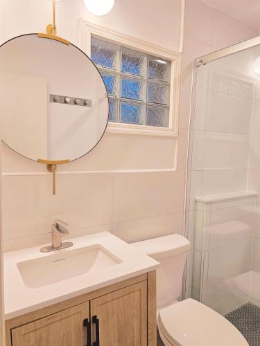 a bathroom with a sink and a toilet and a mirror at Far Out Motel in Starkville
